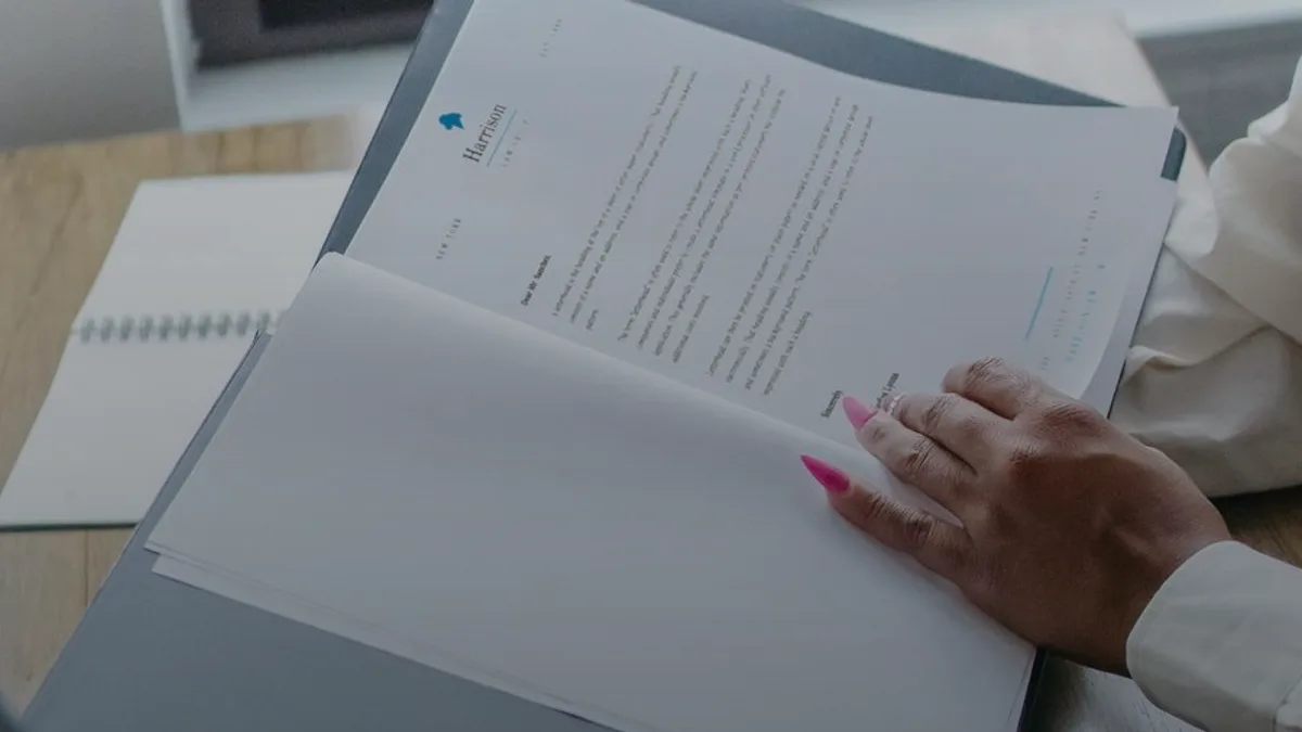 A woman reviewing care and planning documents in a calm home setting.